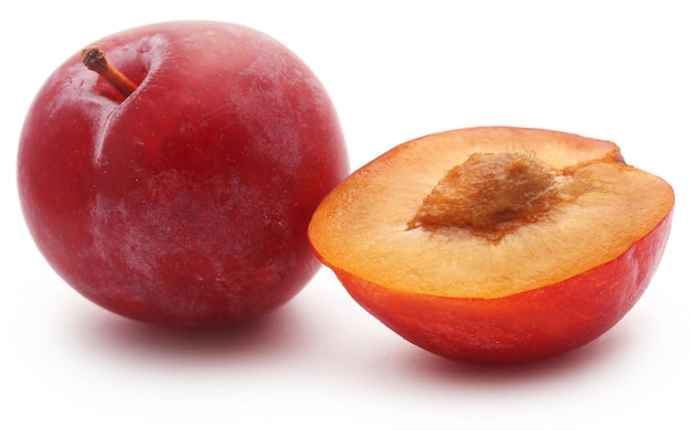 Fresh plums over white background