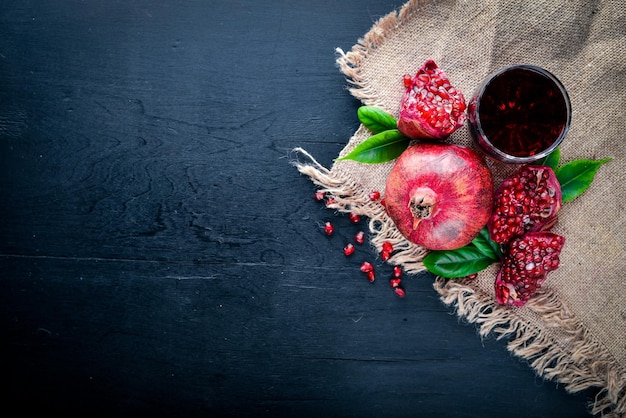 Fresh pomegranate on a dark Wooden surface Top view