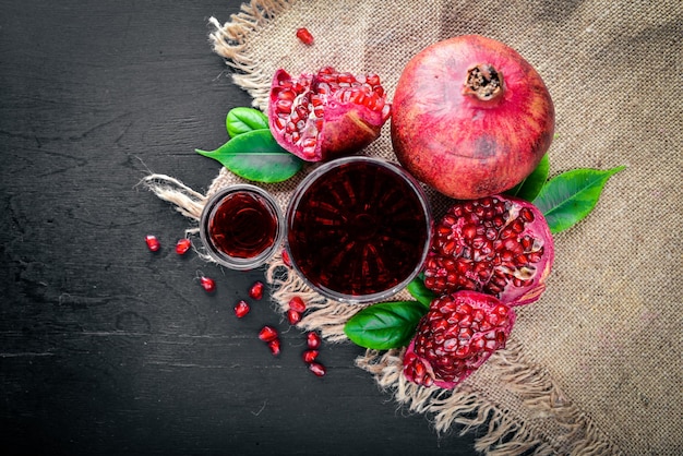 Fresh pomegranate on a dark Wooden surface Top view