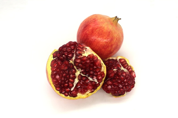 Fresh pomegranate fruits isolated against a white background