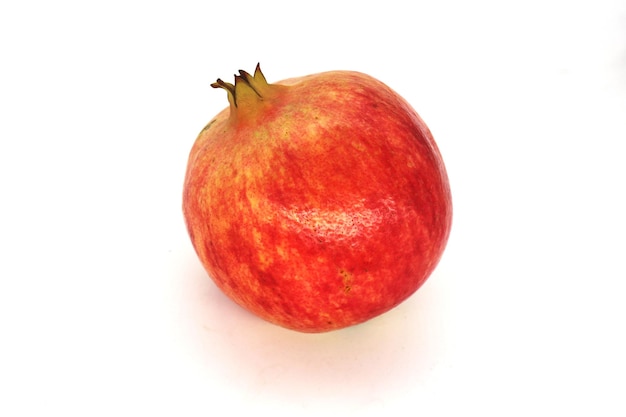 Fresh pomegranate fruits isolated against a white background