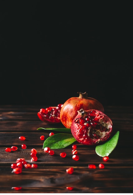 Fresh pomegranate fruits on a rustic wooden background