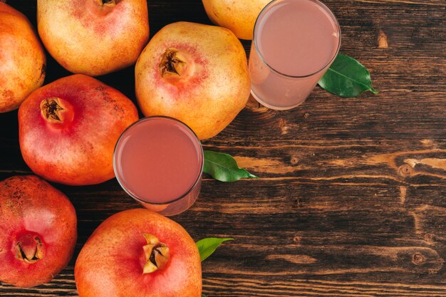 Fresh pomegranate juice on wooden table close up