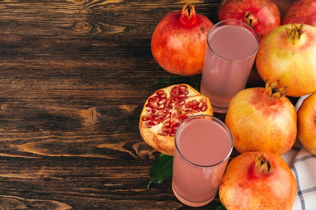 Fresh pomegranate juice on wooden table close up