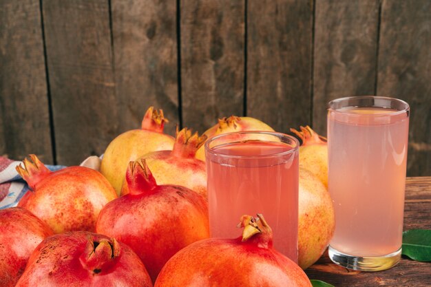 Fresh pomegranate juice on wooden table close up