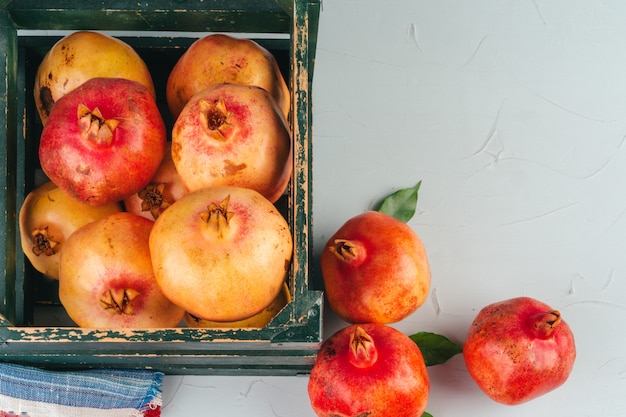 Fresh pomegranates in an old box  on wooden background