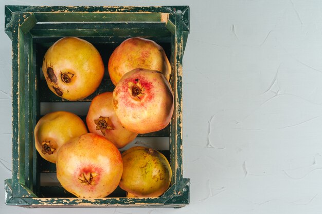 Fresh pomegranates in an old box  