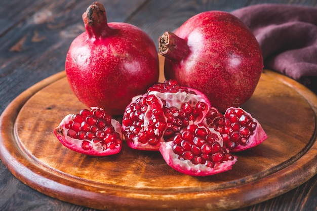 Fresh pomegranates on the wooden table