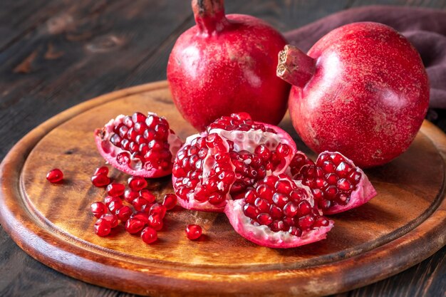 Fresh pomegranates on the wooden table