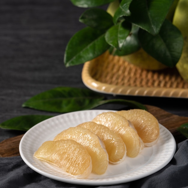 Fresh pomelo on black slate background for Mid-Autumn Festival fruit.