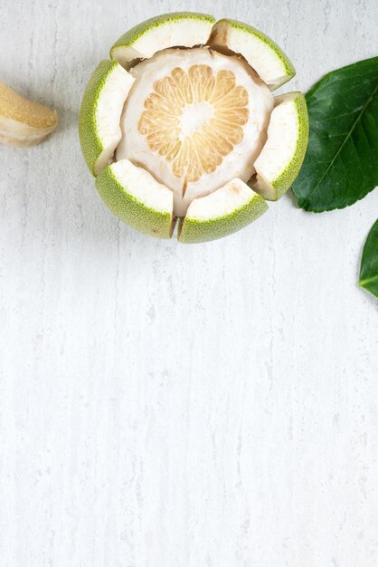 Fresh pomelo fruit on white table background