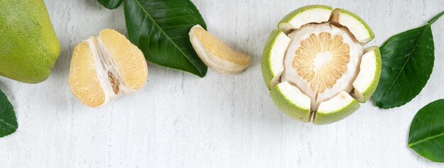 Fresh pomelo fruit on white table background