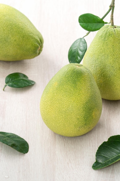 Fresh pomelo fruit on wooden table background