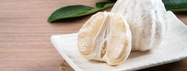 Fresh pomelo fruit on wooden table background