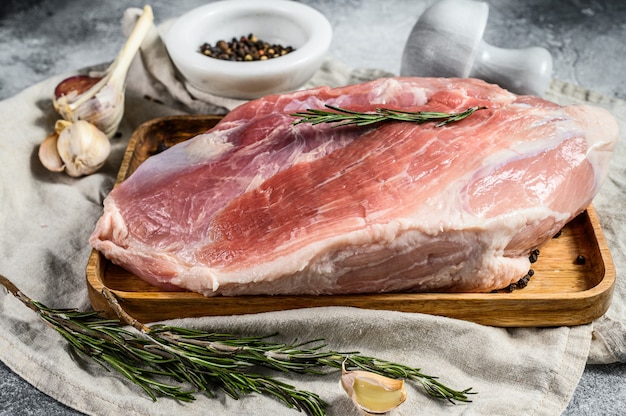 Fresh pork cuts. Raw meat with spices.  hind leg steak. Gray background. Top view