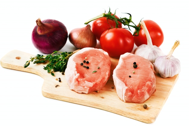 Fresh pork meat steaks with vegetables