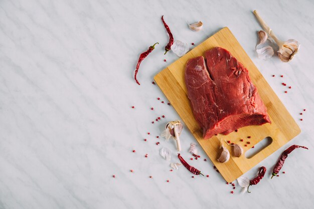 Fresh pork raw fillet on wooden board. Red beef meat on a cutting board.