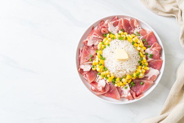 fresh pork raw sliced with rice and corn on plate and ready to cook