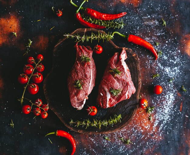 Fresh pork steaks on slate board 