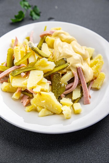 fresh potato salad gherkin sausage mayonnaise ready to eat meal food snack on the table