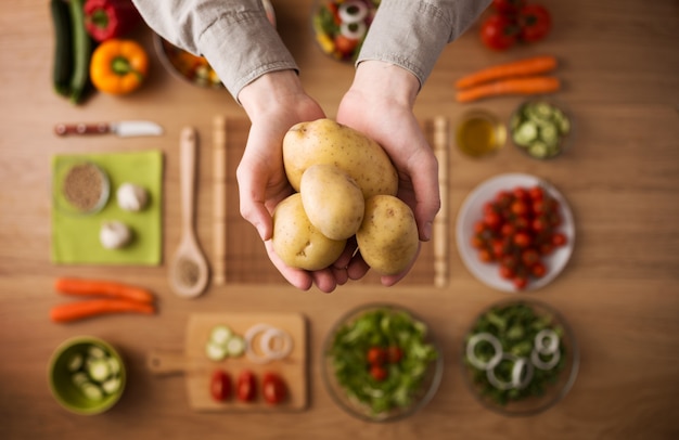 Fresh potatoes in hands