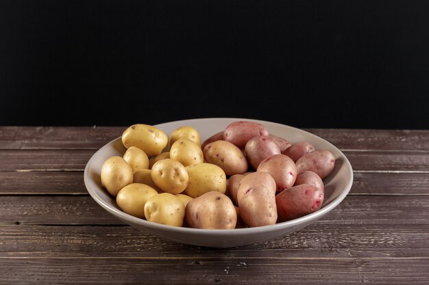 Fresh potatoes on the wood