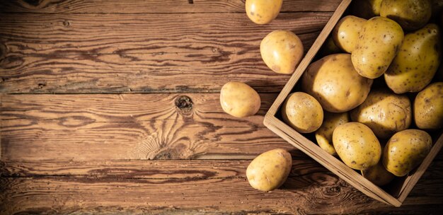 Fresh potatoes On a wooden table