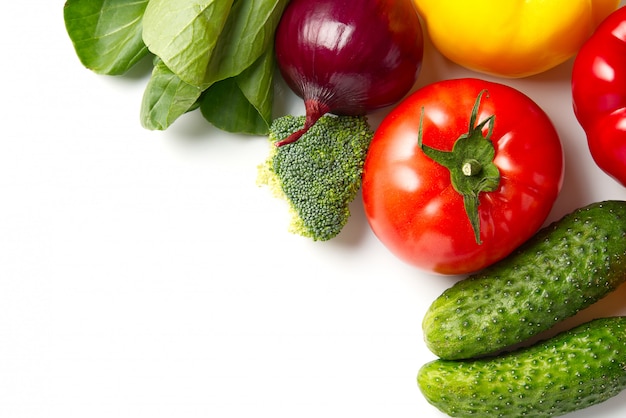 fresh produce raw vegetables, cucumber purple cabbage spinach tomatoes paprika onion broccoli herb, plenty of copy-space. Domestic kitchen. Vegetarian food.