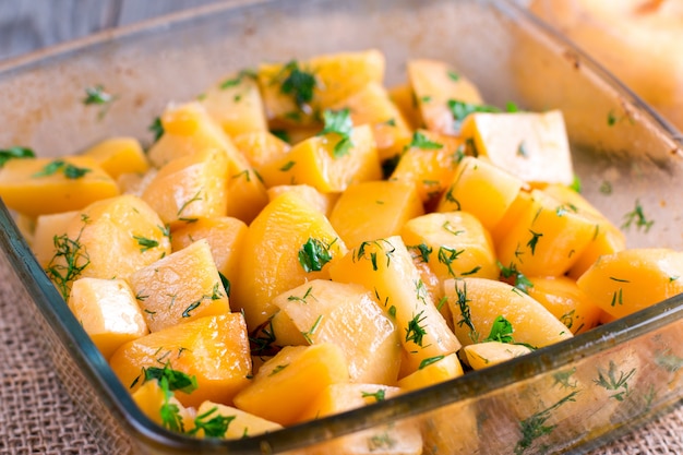 Fresh pumpkin cubes in a baking pan