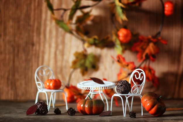 Fresh pumpkin in interior wooden room on forged chair