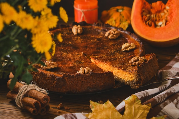 Fresh Pumpkin pie on wooden background top view