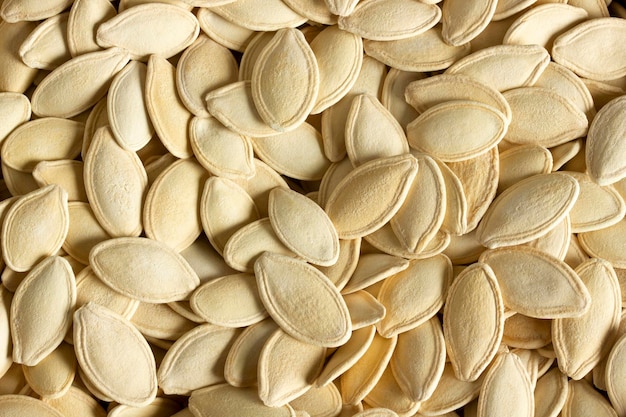 Fresh pumpkin seeds background Closeup