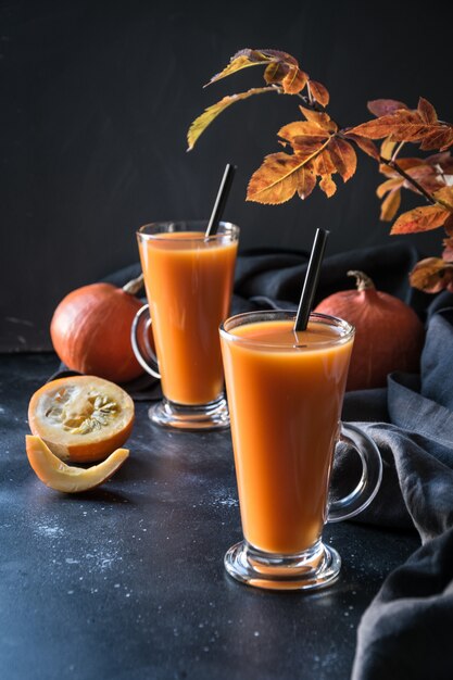 Fresh pumpkin spice smoothie or juice on dark.