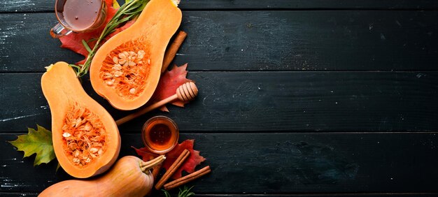 Fresh pumpkin with honey healthy food On a black stone background Top view Free copy space