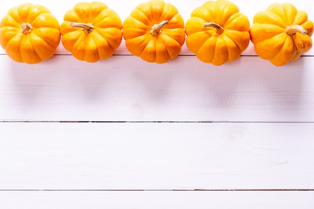 Fresh pumpkins on white surface