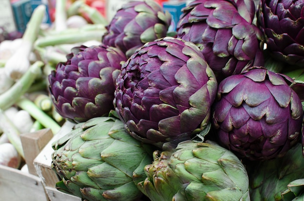 Fresh purple artichokes on in the fruit market.