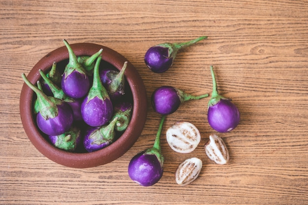 Fresh Purple eggplants on wooden table. 
