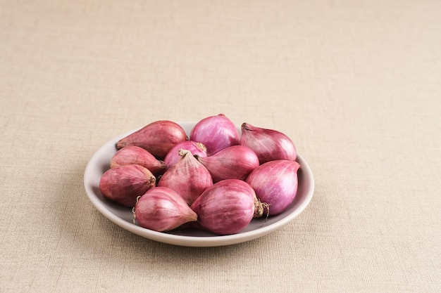 Fresh purple shallots on wooden board Shallots close up