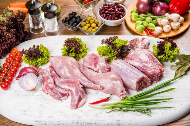 Fresh rabbit meat, carcass, on a wooden table