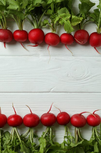 Fresh radish on white wooden background