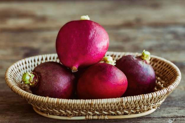 Fresh radish in wood basket put on wooden table