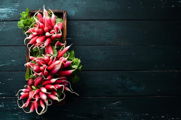 Fresh radish on a wooden table Fresh vegetables Top view Free space for text