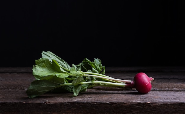 Fresh radishes on an old wooden table