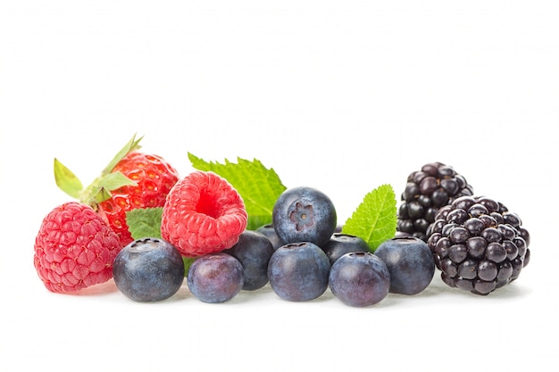 Fresh raspberries, blueberries, blackberries and strawberry with leaves