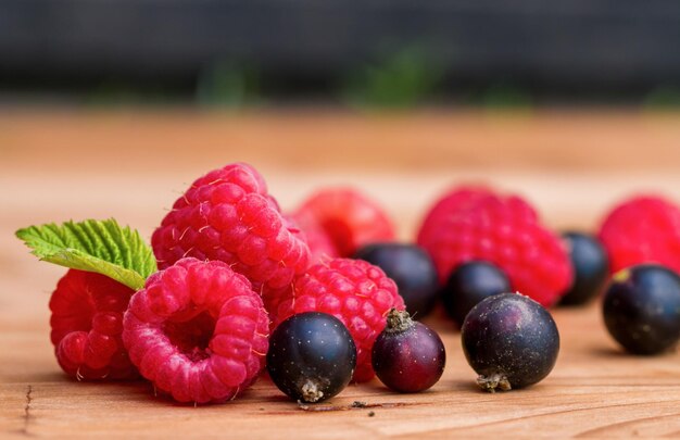 Fresh raspberries and currants on a table close-up