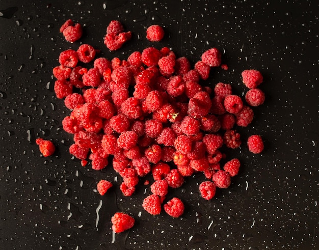 Fresh raspberries on dark background top view Selective focus useful product