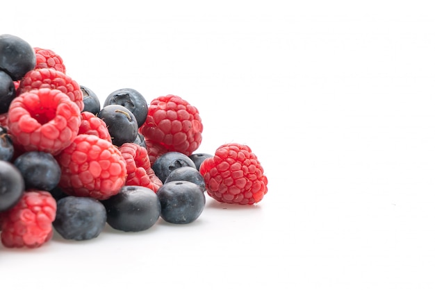 fresh raspberries and fresh blueberries on white background