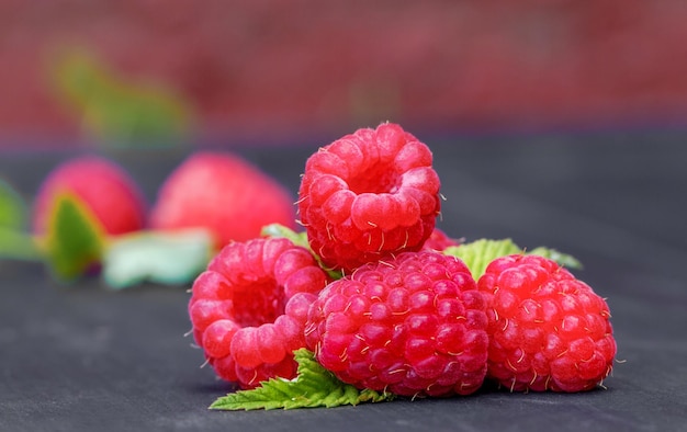 Fresh raspberries with green leaves