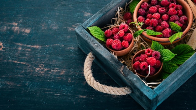 Fresh Raspberry Berries On a wooden background Top view Free space for your text