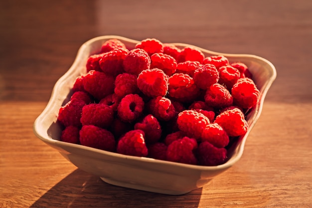 Fresh raspberry in small bowl at kitchen